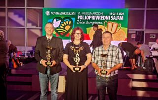 Winners stand with their awards on the ceremony